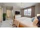Bright bedroom featuring a chandelier, TV, ensuite bath and a large window providing natural light at 411 Belo Ct, Fort Mill, SC 29715