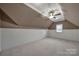 A large bonus room features neutral carpet, a ceiling fan, bead board, and a window at 411 Belo Ct, Fort Mill, SC 29715