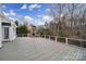 Large wooden deck with a stone fireplace and white railings, perfect for outdoor entertaining at 411 Belo Ct, Fort Mill, SC 29715