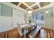 Bright dining room featuring wainscoting, a modern chandelier, and a large window for ample light at 411 Belo Ct, Fort Mill, SC 29715