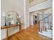 Inviting foyer with hardwood floors, staircase, high ceilings, and a decorative mirror on a wood table at 411 Belo Ct, Fort Mill, SC 29715