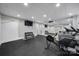 Home gym area equipped with workout equipment, mirrored wall, and rubber flooring at 411 Belo Ct, Fort Mill, SC 29715