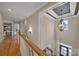 Upstairs hallway featuring hardwood floors, a decorative chandelier, and neutral walls at 411 Belo Ct, Fort Mill, SC 29715