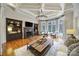 Spacious living room with coffered ceilings, built-in bookshelves, fireplace, and large bay windows at 411 Belo Ct, Fort Mill, SC 29715