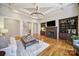 Inviting living room with a fireplace, custom built-ins, hardwood floors, and coffered ceilings at 411 Belo Ct, Fort Mill, SC 29715