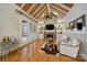 Inviting living room with a brick fireplace, built-in shelving, and French doors to the patio at 411 Belo Ct, Fort Mill, SC 29715
