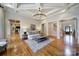 Open-concept living room featuring hardwood floors, coffered ceilings, and seamless flow to other living spaces at 411 Belo Ct, Fort Mill, SC 29715