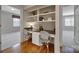 Home office with built-in shelves, granite desk, and wood floors at 411 Belo Ct, Fort Mill, SC 29715