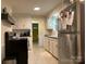 Well-lit kitchen with tile floors and white cabinetry at 412 Miles Rd, Shelby, NC 28150