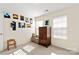 Bright secondary bedroom featuring lots of wall art, a window seat, and built-in storage cabinets at 4462 Haddington Dr, Fort Mill, SC 29707
