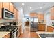 Modern kitchen with stainless steel appliances, granite countertops, and hardwood floors at 4462 Haddington Dr, Fort Mill, SC 29707