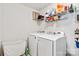 Well-organized laundry room featuring side-by-side washer and dryer and wire storage shelves at 4462 Haddington Dr, Fort Mill, SC 29707