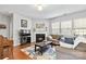 Cozy living room features a fireplace, hardwood floors, and plenty of natural light at 4462 Haddington Dr, Fort Mill, SC 29707