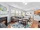 Open concept living room with a fireplace, hardwood floors, and dining area at 4462 Haddington Dr, Fort Mill, SC 29707