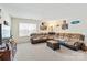 Bright living room featuring a sectional couch, carpeted floors, and TV with decorations at 4462 Haddington Dr, Fort Mill, SC 29707