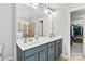Main bathroom showcasing the double sink vanity with a large mirror and an entrance to a walk-in closet at 4462 Haddington Dr, Fort Mill, SC 29707