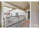 Inviting covered balcony with wood flooring and white railing, great for outdoor enjoyment at 5011 Sharon Rd # B, Charlotte, NC 28210