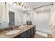 Bathroom featuring a double vanity with decorative granite countertops and shower at 5011 Sharon Rd # B, Charlotte, NC 28210