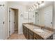 Bathroom featuring a double vanity, granite counters, and neutral tile at 5011 Sharon Rd # B, Charlotte, NC 28210