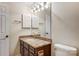 Bathroom vanity boasts a granite countertop, dark wood cabinets and gold fixtures at 5011 Sharon Rd # B, Charlotte, NC 28210