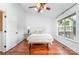Light-filled bedroom with a window view and warm wood floors at 5011 Sharon Rd # B, Charlotte, NC 28210