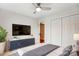 Bedroom with a flat-screen TV, neutral dresser, and a large closet at 5011 Sharon Rd # B, Charlotte, NC 28210