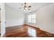 Neutral bedroom featuring hardwood floors, ceiling fan, and natural light at 5011 Sharon Rd # B, Charlotte, NC 28210