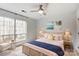 Sunlit bedroom featuring wicker accents, a large window, and stylish decor at 5011 Sharon Rd # B, Charlotte, NC 28210