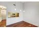 Open dining area with wood floors and pendant lighting, adjacent to the kitchen and living spaces at 5011 Sharon Rd # B, Charlotte, NC 28210