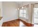 Bright dining area features hardwood floors, modern pendant lights, and sliding glass door access to the outdoor space at 5011 Sharon Rd # B, Charlotte, NC 28210