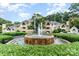 Exterior of the community featuring a water fountain, landscaping, and multiple residential buildings at 5011 Sharon Rd # B, Charlotte, NC 28210