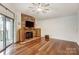 Spacious living room features wood floors, stone fireplace, and a sliding glass door at 5011 Sharon Rd # B, Charlotte, NC 28210
