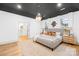 Well-lit bedroom features neutral colors, a stylish pendant light, and an en-suite bathroom at 5147 Star Magnolia Ct, Clover, SC 29710