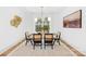 Bright dining room features modern light fixture and an eye-catching art piece above the wainscotting at 5147 Star Magnolia Ct, Clover, SC 29710