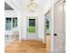 Bright entryway featuring wood floors, a stylish light fixture, and a glass door leading outside at 5147 Star Magnolia Ct, Clover, SC 29710