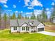 New construction single-Gathering home featuring a gray roof and green lawn on a sunny day at 5147 Star Magnolia Ct, Clover, SC 29710
