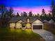 New construction home at dusk, featuring a landscaped front yard and a two-car garage at 5147 Star Magnolia Ct, Clover, SC 29710