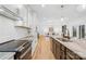 Bright, modern kitchen with white cabinetry, marble countertops and stainless steel appliances at 5147 Star Magnolia Ct, Clover, SC 29710