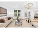 Bright and airy living room featuring neutral tones and an outdoor view, with overhead light fixture at 5147 Star Magnolia Ct, Clover, SC 29710