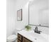 This powder room has a modern faucet and dark wood vanity with a view of nature outside the window at 5147 Star Magnolia Ct, Clover, SC 29710