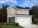 Two-story home featuring light green and gray siding and a two-car garage at 5208 Georgette Trl, Cherryville, NC 28021