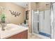 Bright bathroom featuring double sinks, soaking tub, and glass-enclosed shower at 5472 Ives Nw St, Concord, NC 28027
