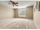 Cozy bedroom featuring neutral carpet, a ceiling fan, and natural light from the window at 5472 Ives Nw St, Concord, NC 28027
