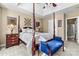 Spacious bedroom with four-poster bed, tray ceiling, and coordinated furniture at 5472 Ives Nw St, Concord, NC 28027