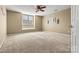 Bedroom with neutral carpet and a ceiling fan, showcasing a calm and relaxing space at 5472 Ives Nw St, Concord, NC 28027