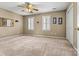 Spacious bedroom with neutral carpet, ceiling fan, and natural light from the window at 5472 Ives Nw St, Concord, NC 28027