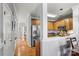 Hallway leading to kitchen with stainless steel refrigerator and wood cabinets at 5472 Ives Nw St, Concord, NC 28027