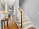 Inviting hallway featuring hardwood floors and stairs with white painted risers at 5472 Ives Nw St, Concord, NC 28027