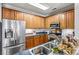 Well-lit kitchen featuring stainless steel appliances and plenty of wooden cabinetry at 5472 Ives Nw St, Concord, NC 28027
