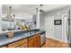 Kitchen with wood cabinets, stainless steel appliances and a view into the living room at 5472 Ives Nw St, Concord, NC 28027